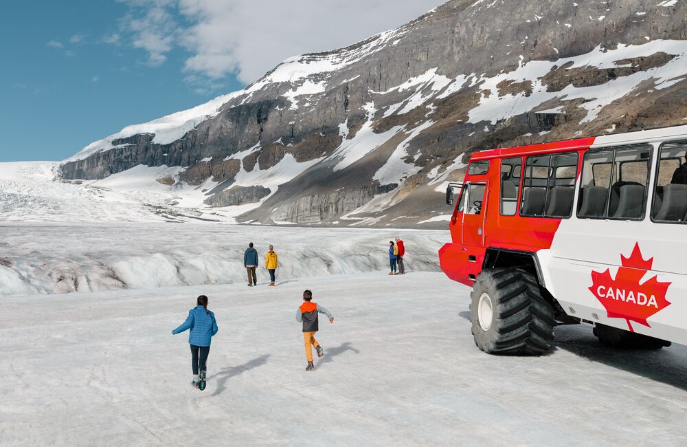 Family exploring the Athabasca Glacier on the Columbia Icefield Adventure